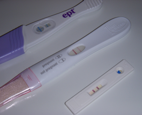 Image shows three pregnancy tests, all with a positive result