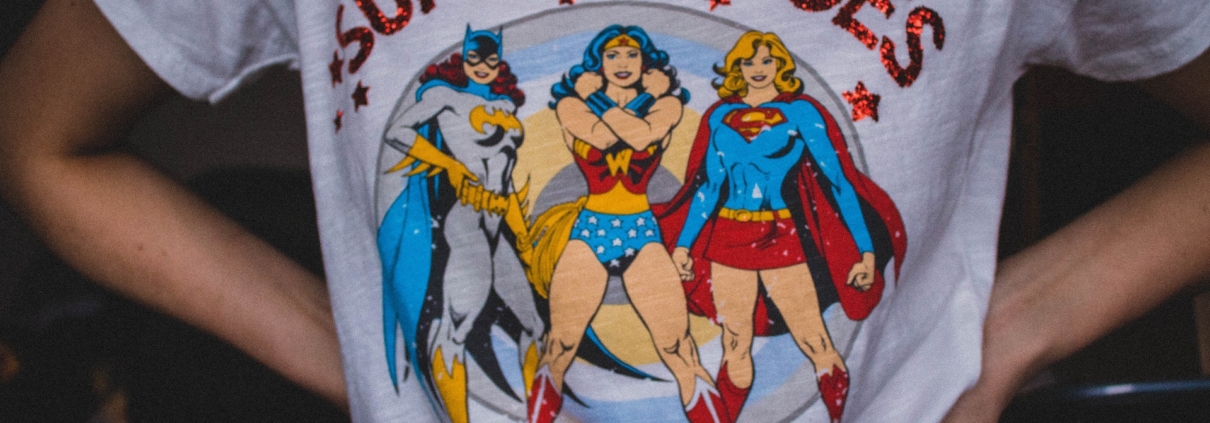 Person wearing t-shirt with women superheroes on the front