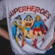 Person wearing t-shirt with women superheroes on the front