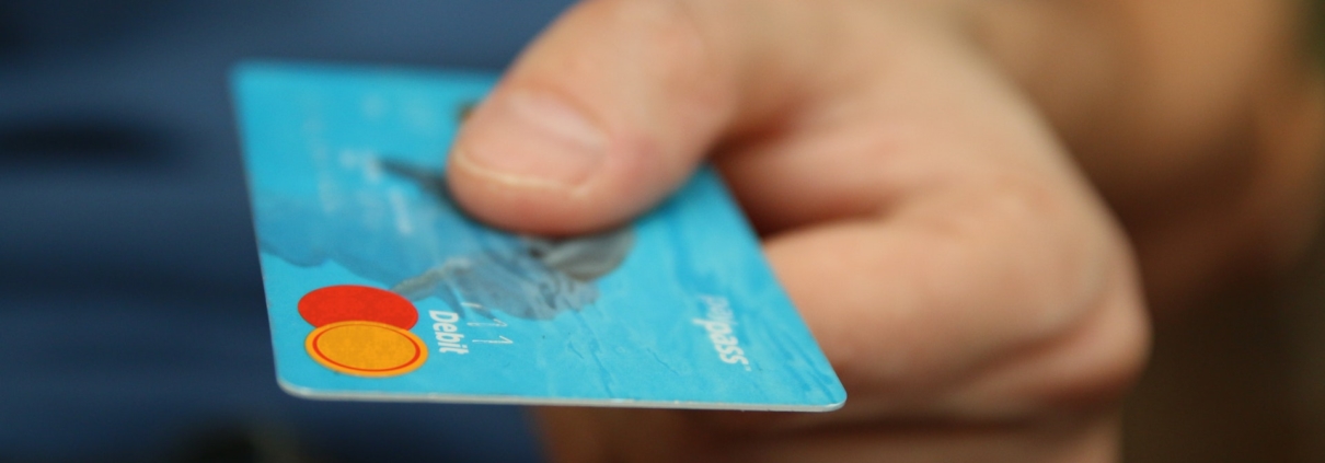 Hand holding a blue credit card