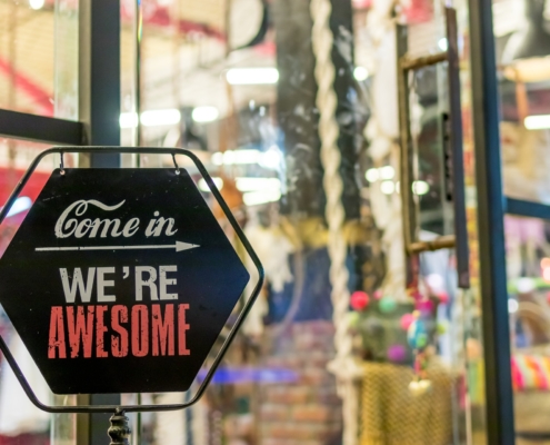 Shop sign that says "Come in, we're awesome"