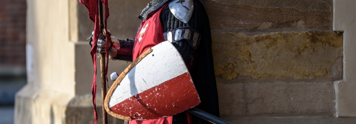 Knight in armour standing guard at a building