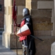 Knight in armour standing guard at a building