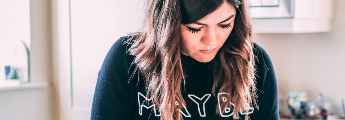 young woman wearing 'maybe baby' top